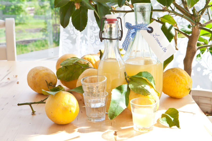 Bottles of the Italian limoncello drink and lemons