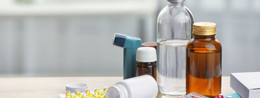 Different medicines and pills on wooden table