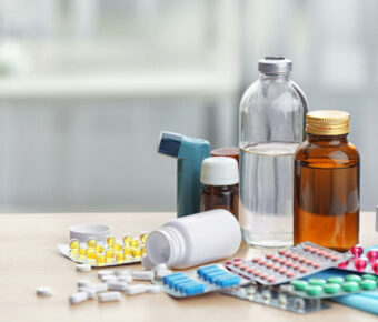 Different medicines and pills on wooden table