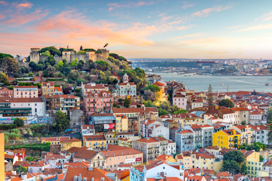 Stunning sunset over Lisbon's skyline from Sao Jorge Castle, highlighting the city's iconic architecture and vibrant colors