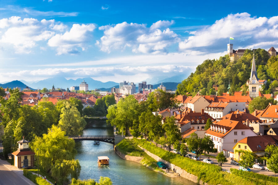 Scenic panorama of Ljubljana, Slovenia, featuring its historic buildings and vibrant city life against a picturesque backdrop