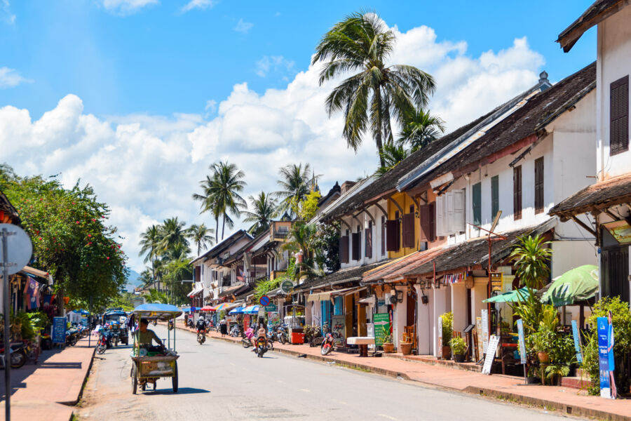 The skyline of Luang Prabang, Laos, featuring charming street houses and lush greenery in the background