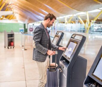 Man using the check-in machine at the airport