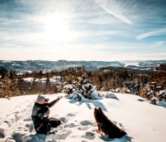 Man with pet dog at a winter park