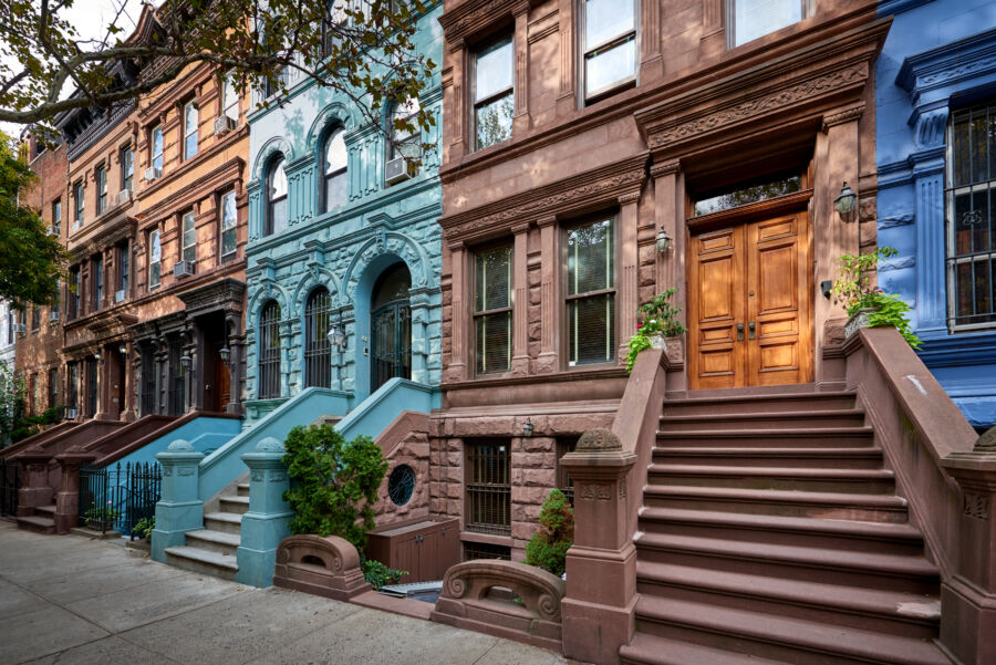 Historic brownstones line a street in a famous Manhattan neighborhood, exemplifying the charm of New York City's architecture