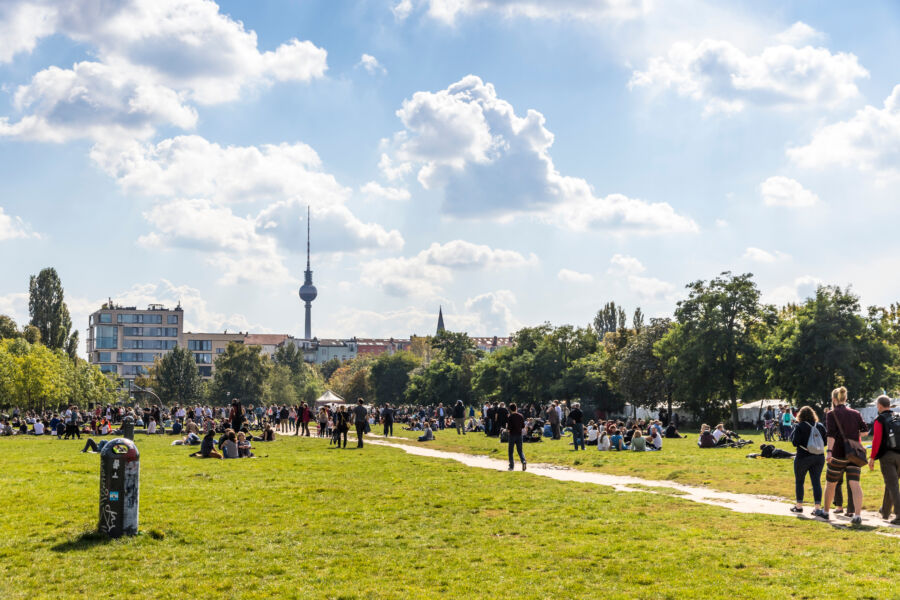 People relax and socialize under the sun at Mauerpark in Berlin on a pleasant Sunday afternoon