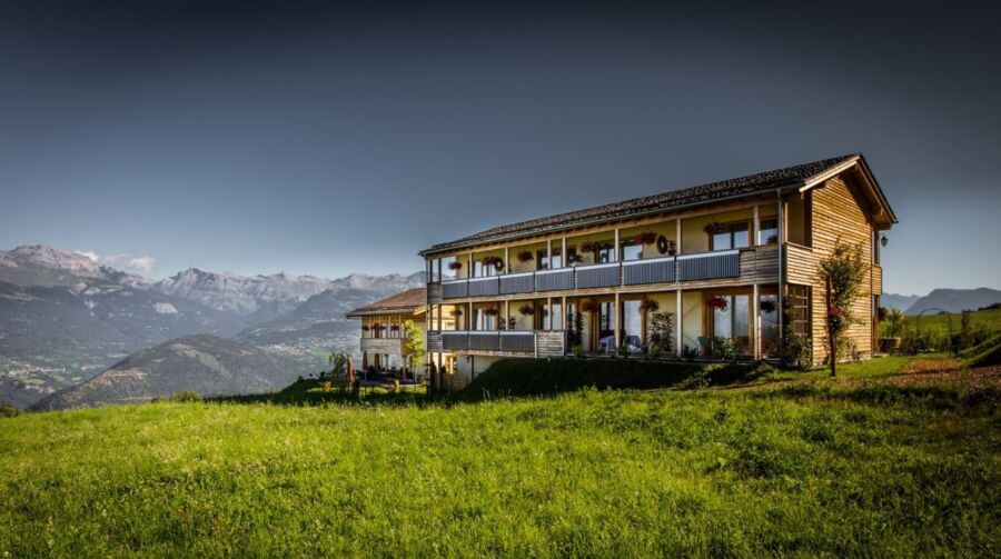 Exterior view of Maya Boutique Hotel in Switzerland, showcasing its charming architecture and surrounding landscape.