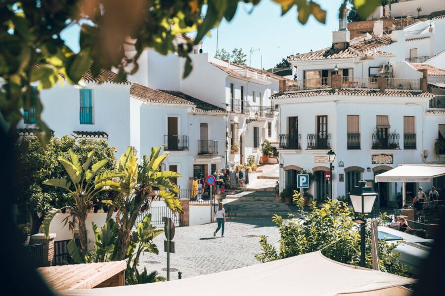 Charming Mediterranean town square with whitewashed buildings, terracotta roofs, and vibrant atmosphere.