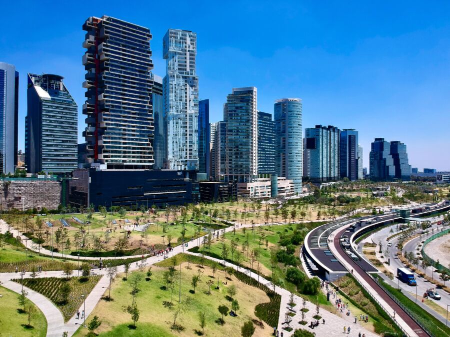 Aerial view of a vibrant park in Mexico City, surrounded by modern buildings and lush greenery