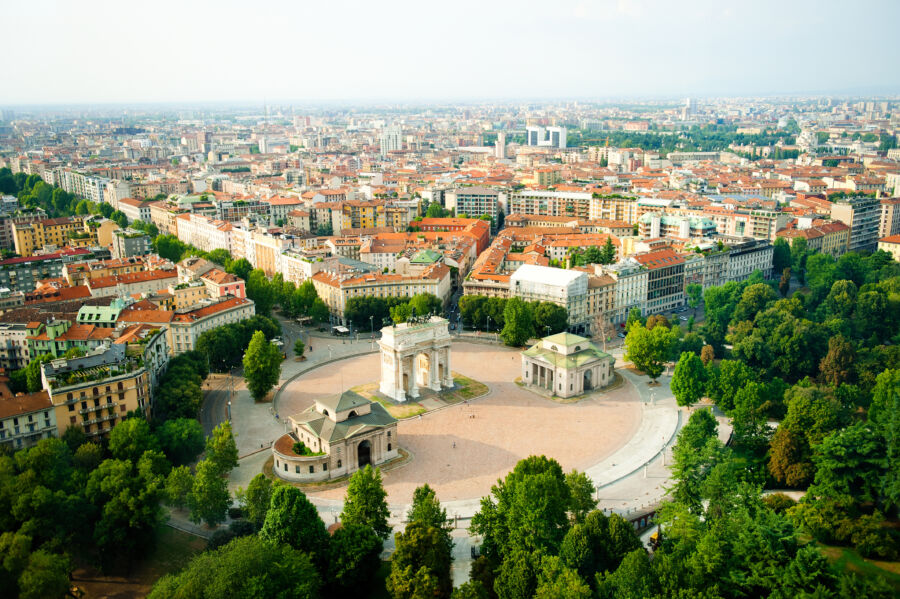 Scenic panorama of Milan, Italy, showcasing Porta Sempione arch with the vibrant cityscape in the background.
