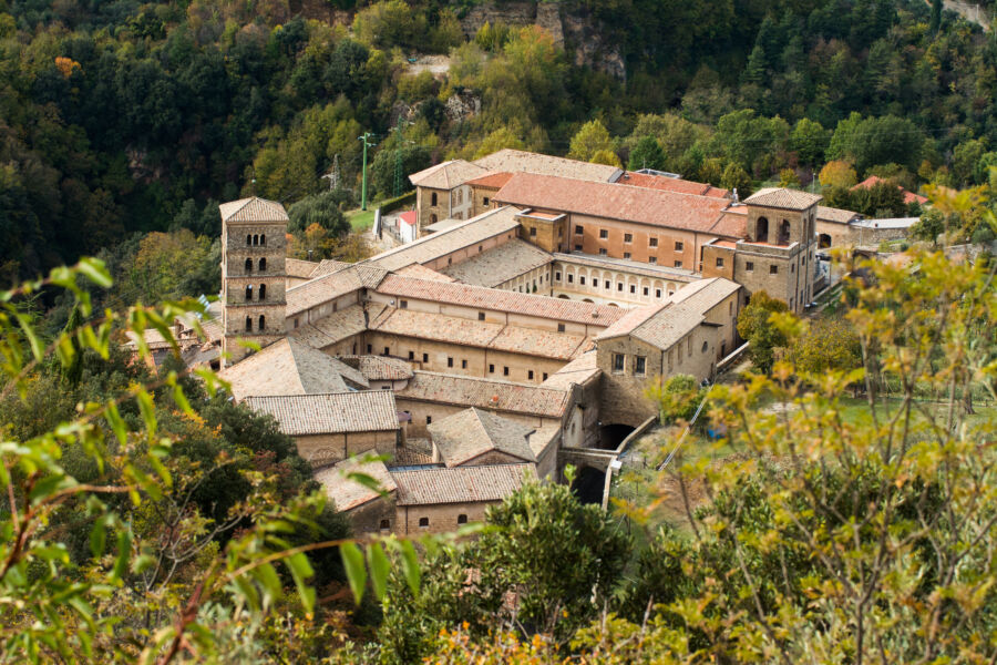 The medieval Saint Scholastica monastery in Subiaco, nestled among trees, founded by Benedict of Nursia