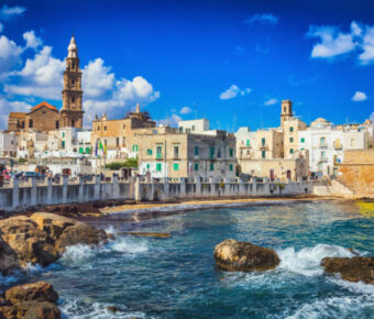 Scenic cityscape of Monopoli, Bari, showcasing charming architecture and coastal views under a clear blue sky