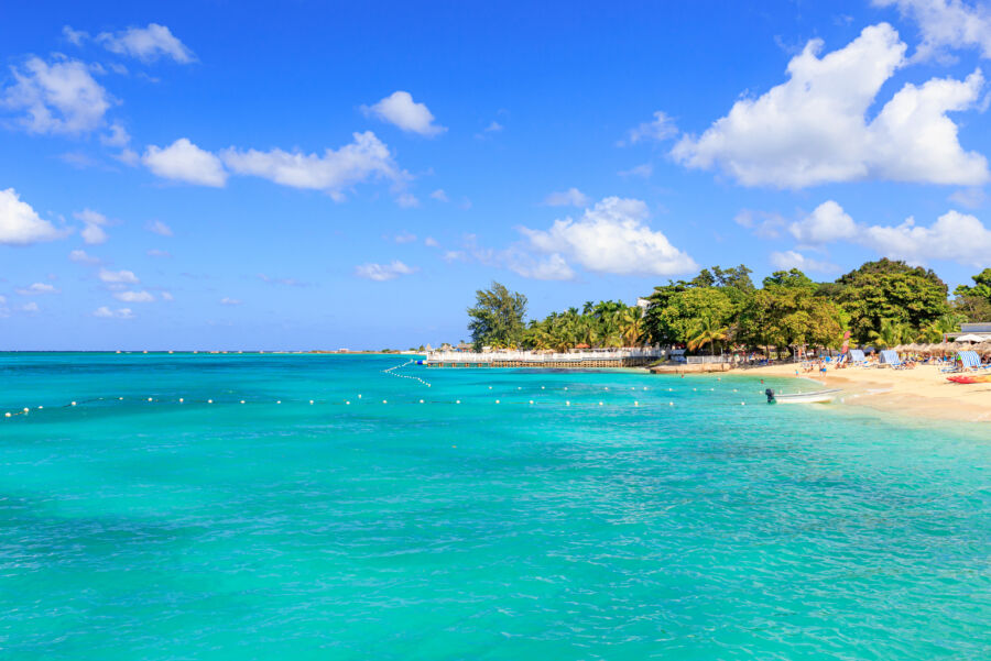 Picturesque scene of Doctor's Cave Beach in Montego Bay, Jamaica, with soft sand and inviting turquoise sea