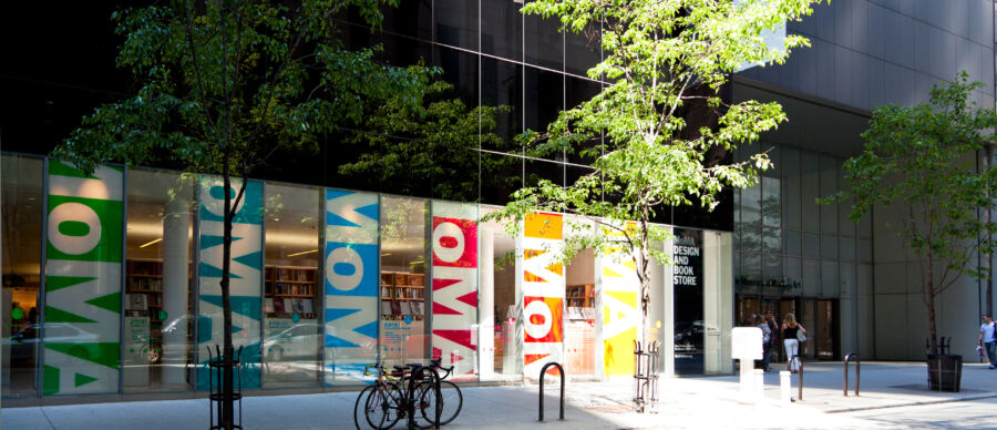 Exterior view of the Museum of Modern Art (MoMA) in New York, showcasing its contemporary architecture and urban surroundings