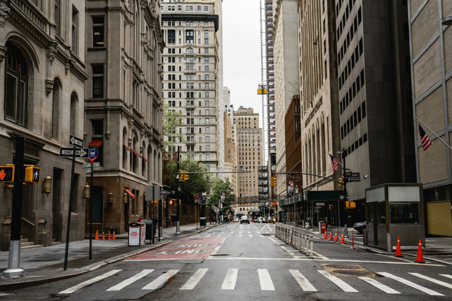 Rain-soaked Manhattan streets featuring New York architecture and rental buildings in a close-up perspective