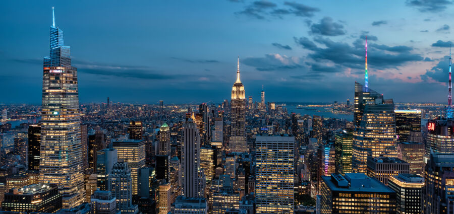 Nighttime skyline of New York City, highlighting its famous skyscrapers and vibrant lights