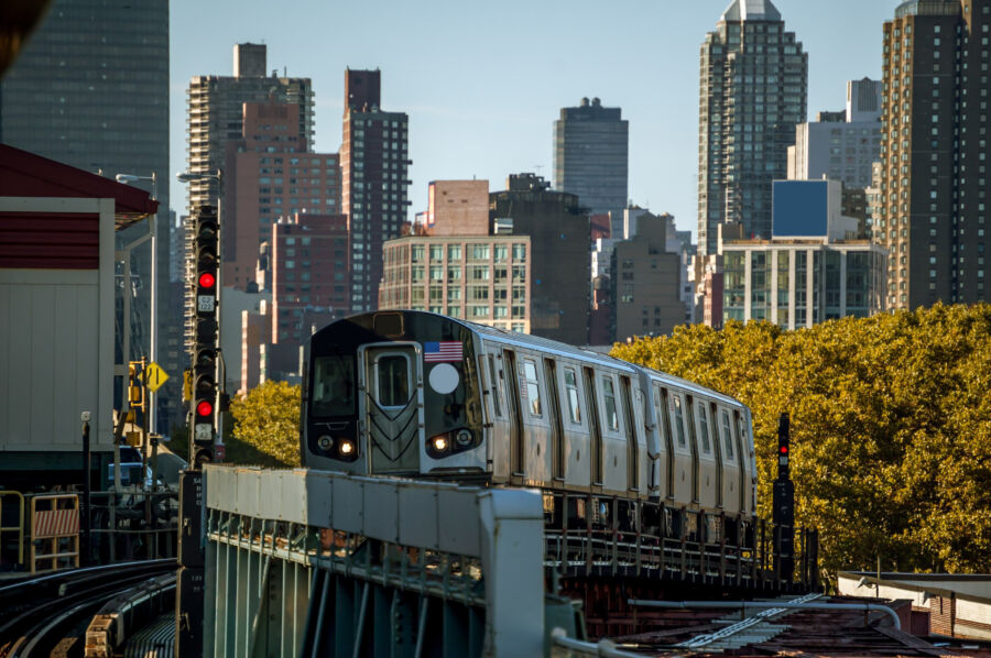 New York subway train operates above ground, illustrating the city's unique blend of transportation and architecture