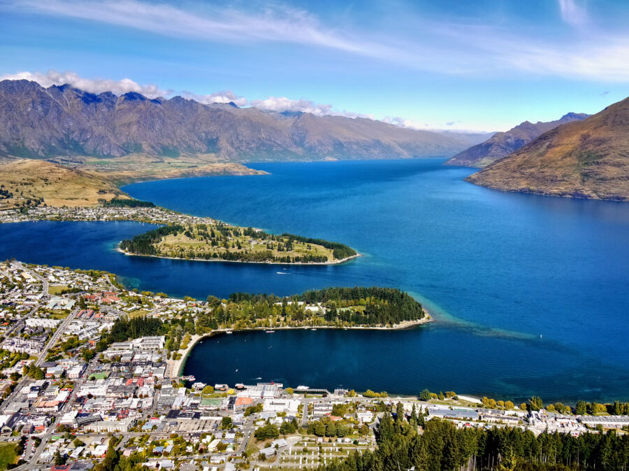 Aerial view of Queenstown, New Zealand, showcasing downtown, Lake Wakatipu, and the stunning Southern Alps