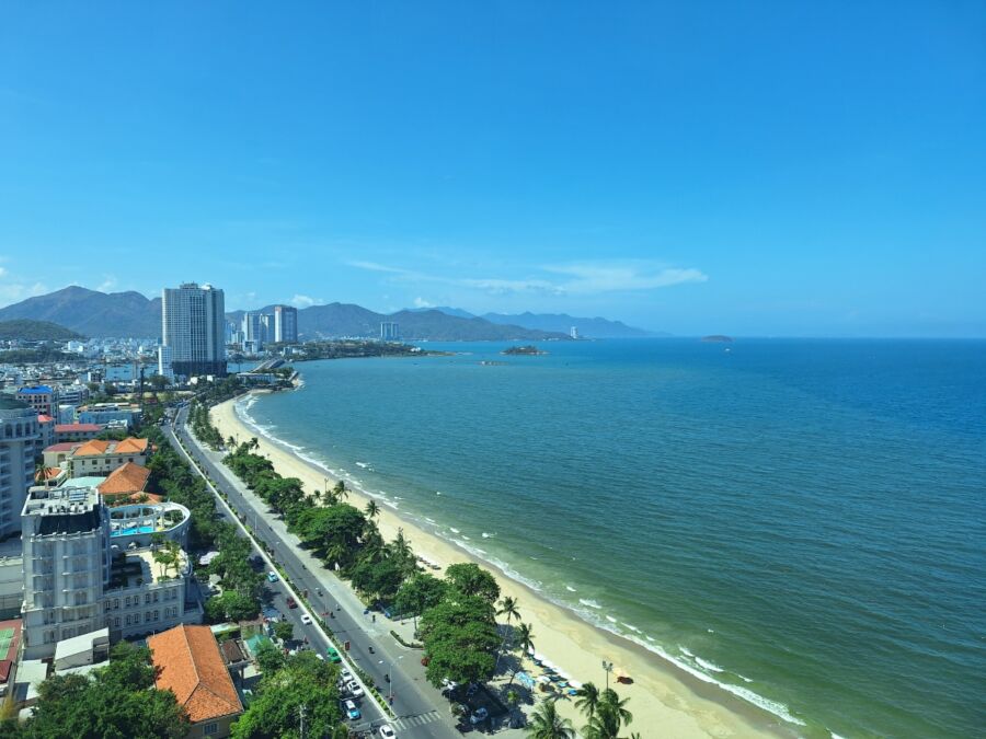 Scenic view of Nha Trang Beach, a long stretch of sand alongside Tran Phu Road in Vietnam, showcasing clear blue waters