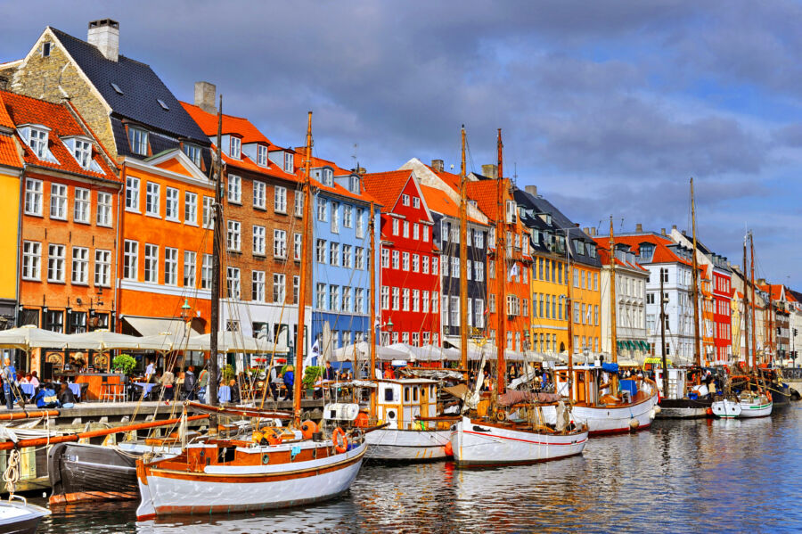 Nyhavn district in Copenhagen, Denmark, showcasing vibrant, historic buildings lining the scenic canal