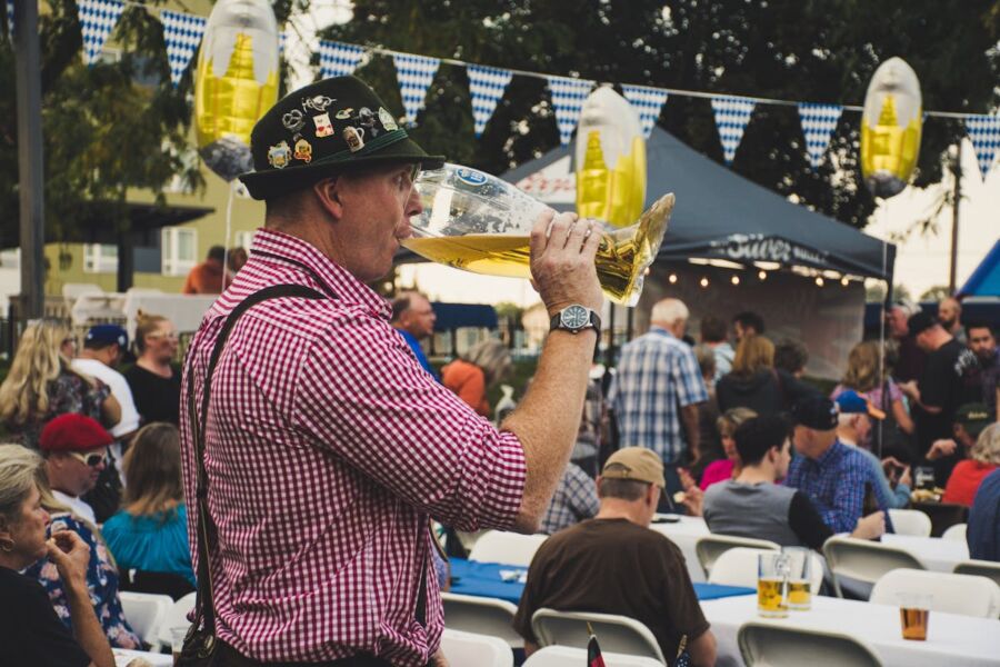 Munich Oktoberfest festival scene with beer, traditional attire, and joyful camaraderie.