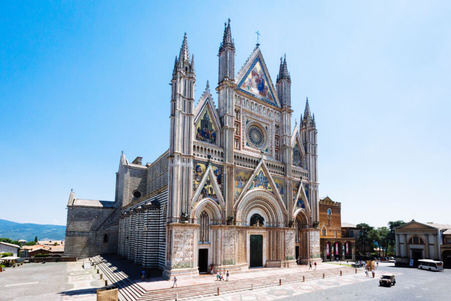 Exterior view of the 14th-century Gothic Duomo di Orvieto, showcasing its intricate architecture in Orvieto, Italy