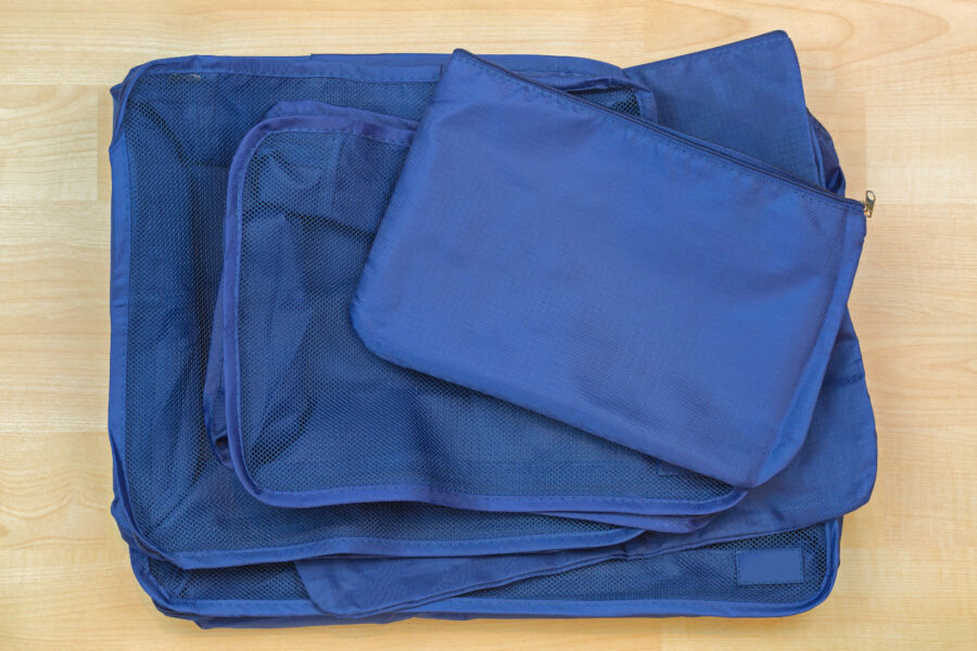 Set of blue cube bags for travel organization, featuring multiple designs to enhance packing efficiency and convenience