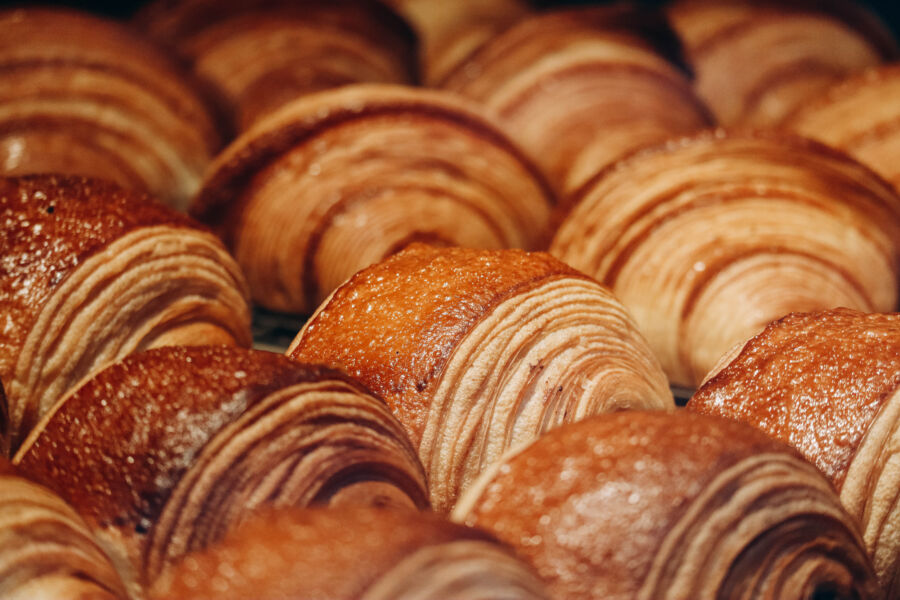 Close-up of a flaky, golden pain au chocolat, showcasing its rich chocolate filling and buttery layers