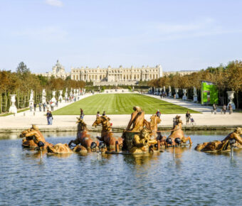 The Apollo Fountain at Versailles, featuring exquisite architecture and lush gardens, a highlight of French elegance