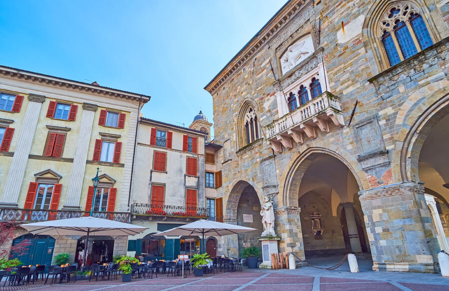 Statue of Torquato Tasso in front of Palazzo della Ragione, set in the beautiful Piazza Vecchia, Bergamo, Italy