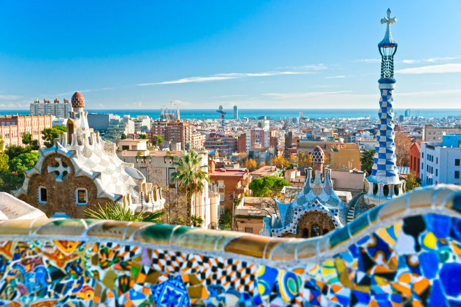 Panoramic view of Park Guell in Barcelona, showcasing vibrant mosaics and unique architectural designs