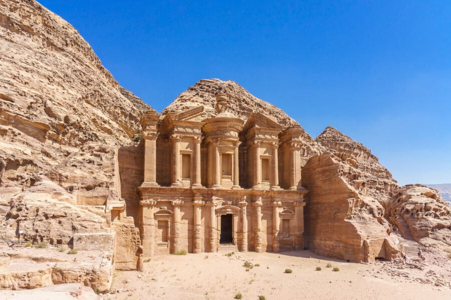 The iconic facade of Ad Deir, a grand monastery in the ancient city of Petra, Jordan, showcasing its remarkable architecture