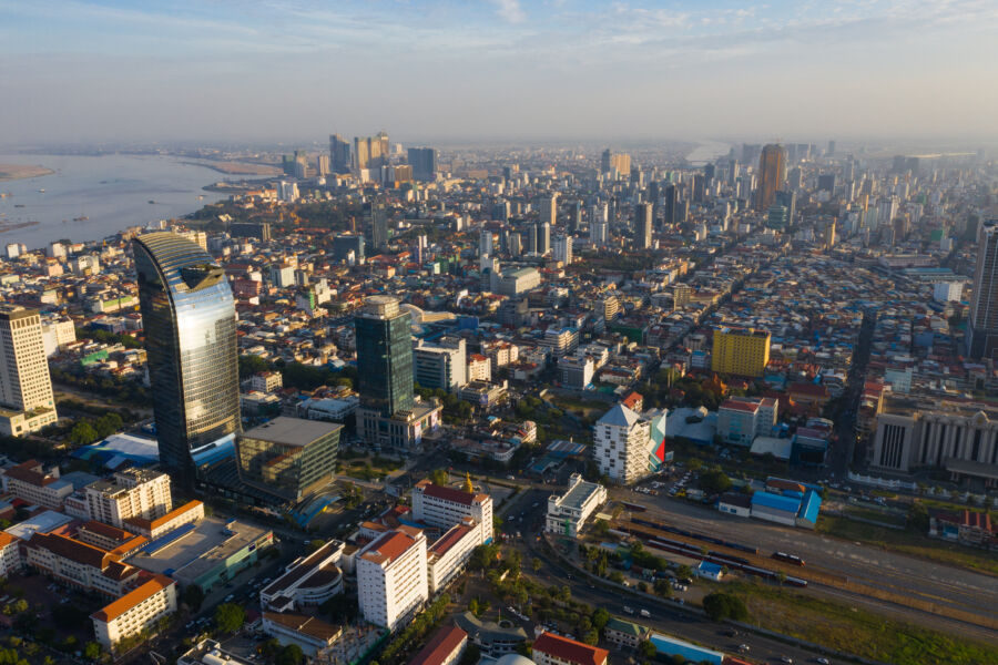 Aerial view of Phnom Penh at sunset, highlighting a colorful skyline and vibrant landscape