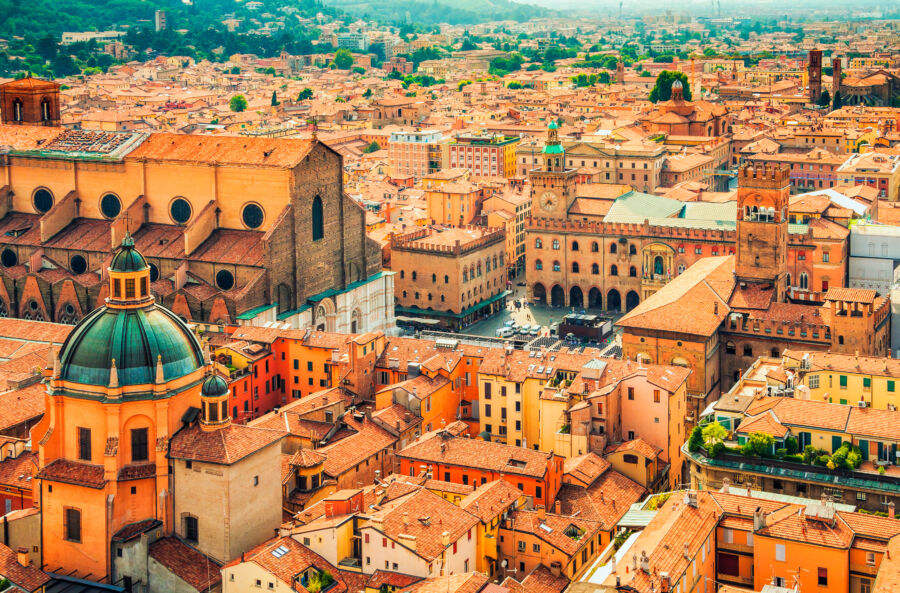 Aerial cityscape of Piazza Maggiore in Bologna, Italy, featuring its iconic buildings and bustling public space