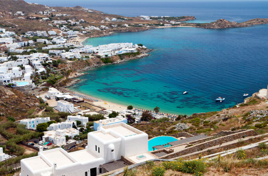 Scenic view of Platis Gialos beach on Mykonos island, showcasing its inviting sands and vibrant turquoise waters