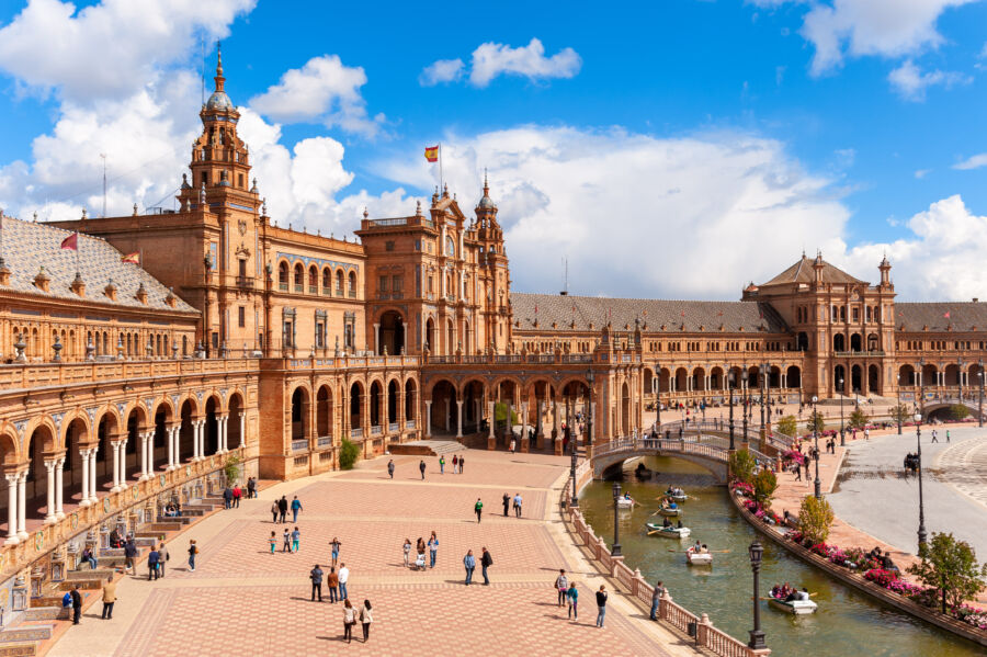 The majestic Plaza de España in Seville, featuring its grand semicircular building and beautiful fountains