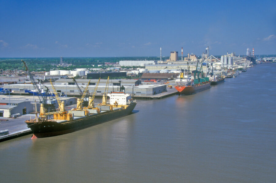 Panoramic view of the bustling Port of Savannah, showcasing ships and containers against a clear blue sky