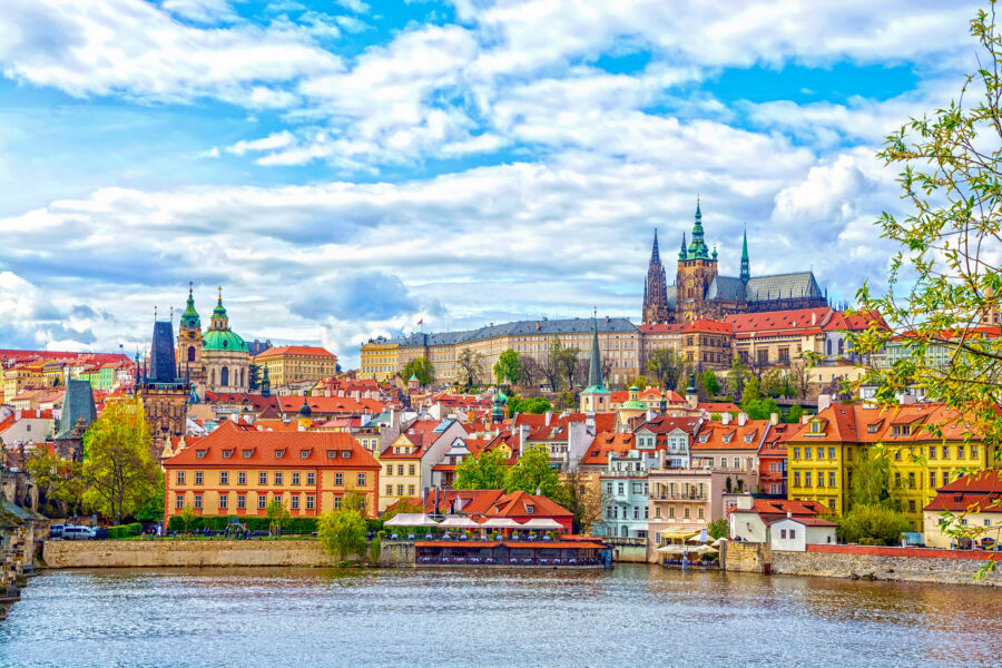 Scenic view of Prague Castle and St. Vitus Cathedral from the Vltava River, showcasing the beauty of Bohemia, Czech Republic