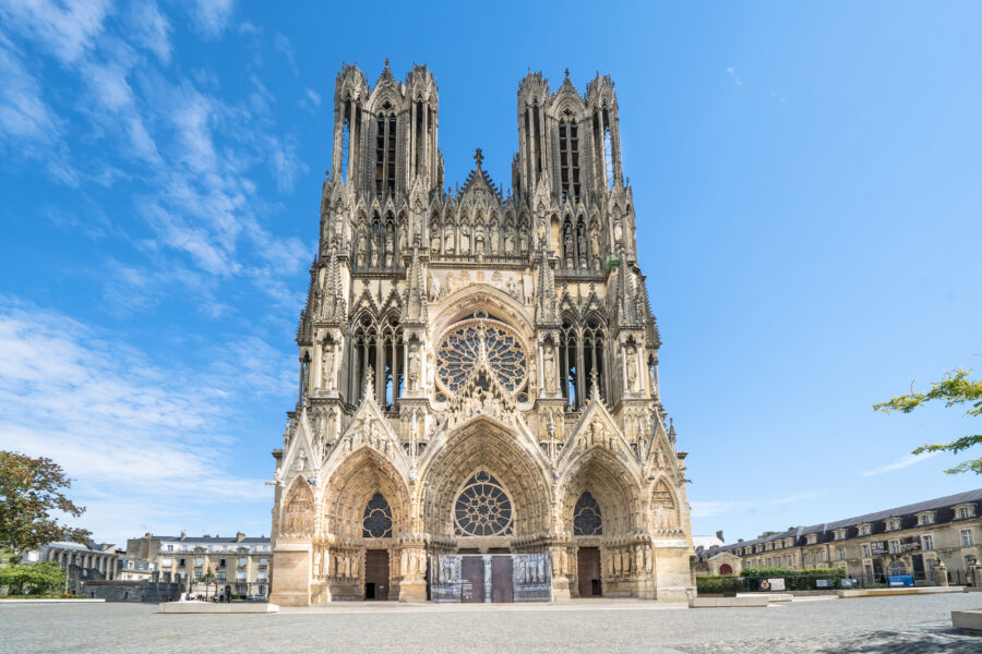 Stunning view of the Cathedral of Reims, showcasing its intricate facade and majestic towers against a clear sky