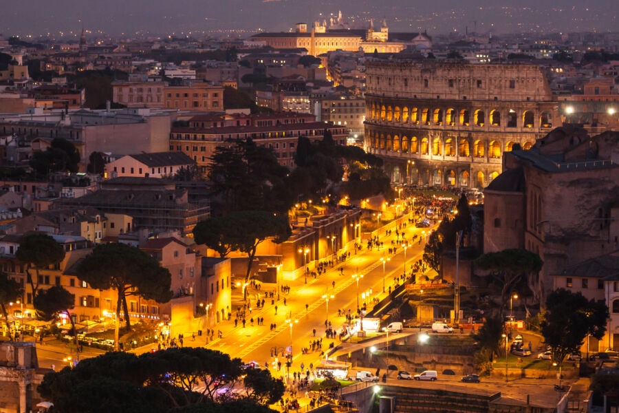 Stunning view of Rome at night, featuring lit landmarks and bustling streets, capturing the essence of the city