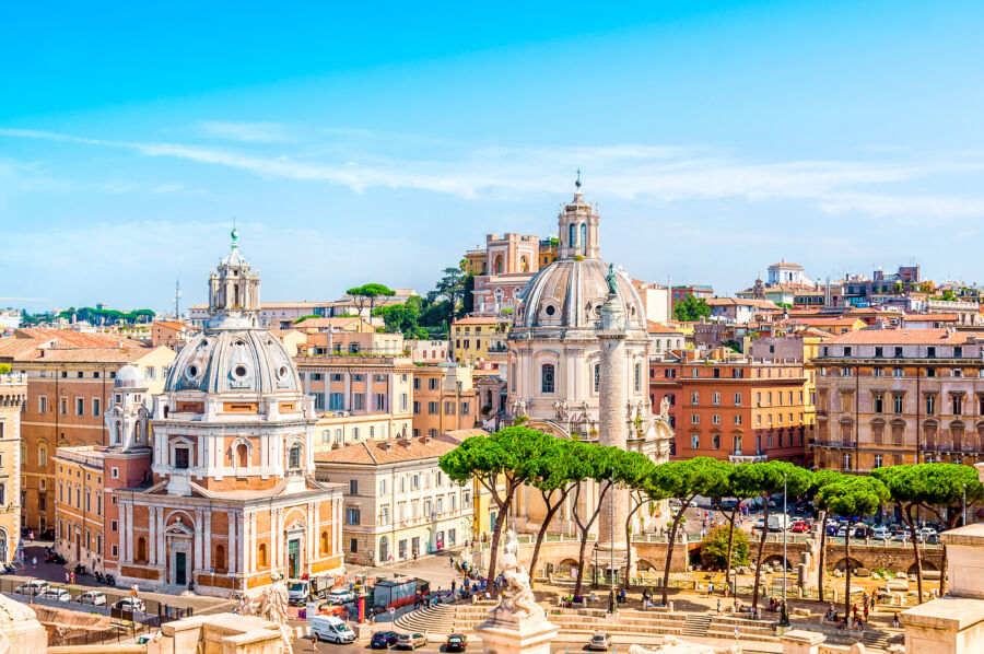 Panoramic view of Rome, Italy, showcasing its iconic skyline with historic buildings and landmarks under a clear sky