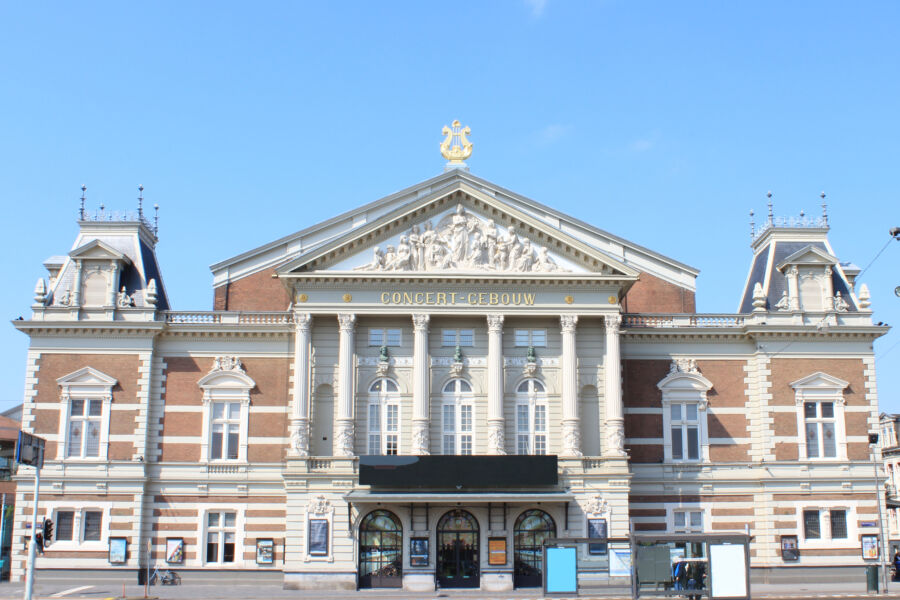 Exterior view of the Royal Concertgebouw in Amsterdam, highlighting its impressive architecture and surrounding landscape