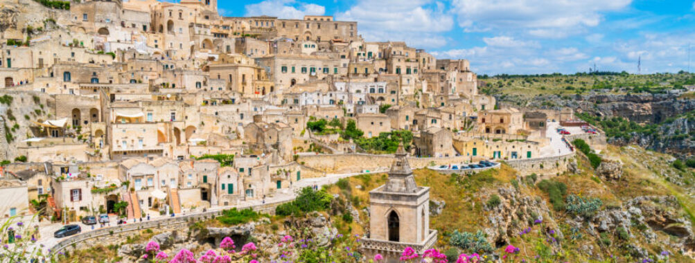 Panoramic view of Matera's Sassi district, featuring historic stone architecture and dramatic landscapes in Basilicata, Italy