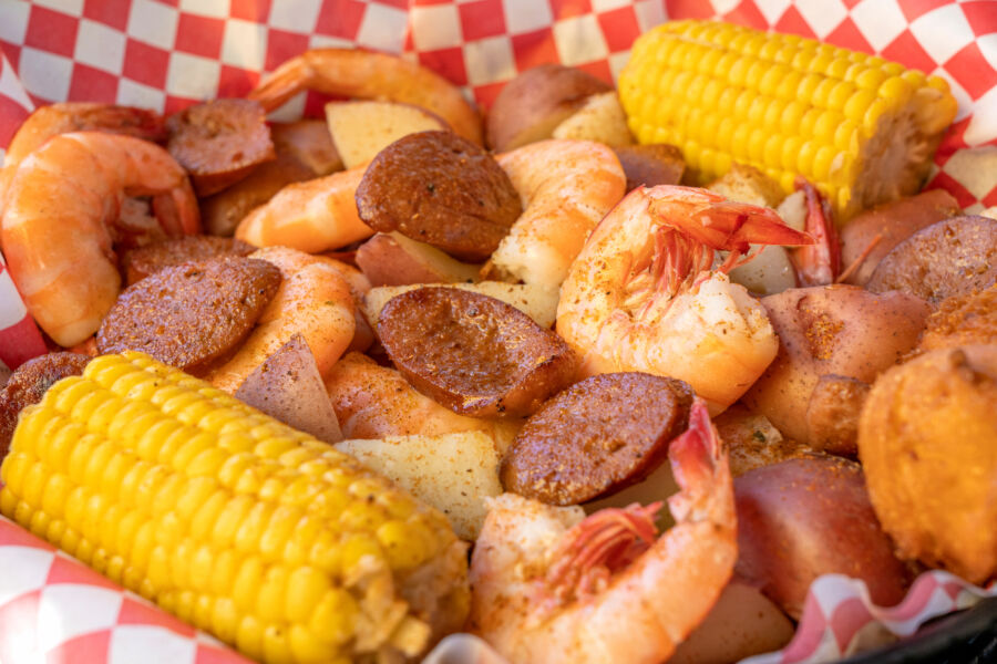 Close-up of a traditional Low Country Boil with shrimp, sausage, potatoes, corn, and hush puppies, from Savannah, Georgia