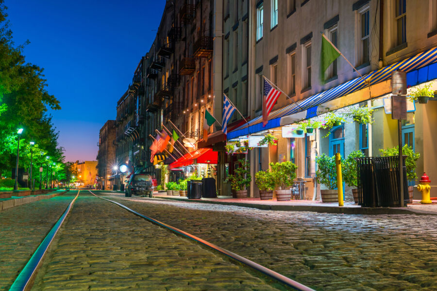 Vibrant shops and restaurants line River Street in downtown Savannah, showcasing the area's lively atmosphere and charm