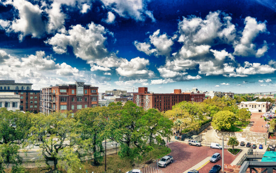 Panoramic aerial view of Savannah, Georgia's skyline in spring, highlighting vibrant trees and city landmarks