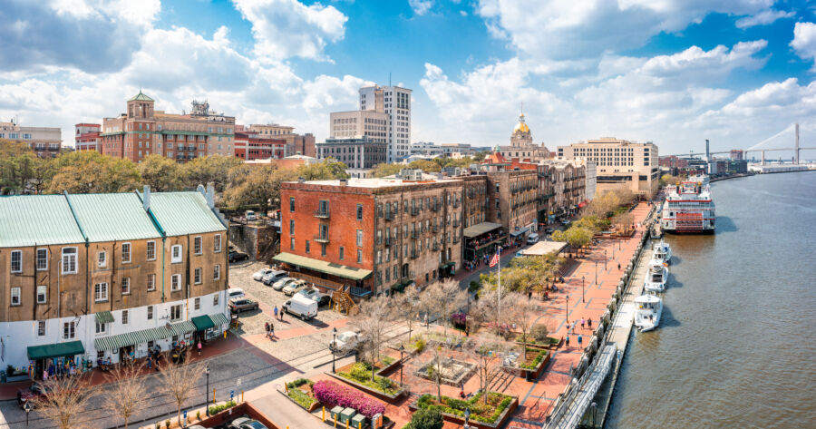 Scenic aerial view of Savannah, Georgia, featuring the skyline and River Street, surrounded by vibrant greenery and historic sites