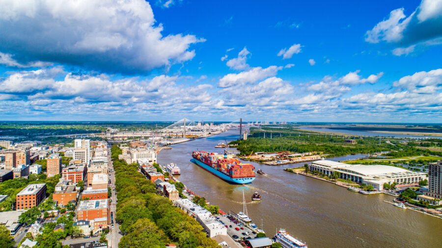 Aerial view of the Savannah River with the downtown skyline of Savannah, Georgia, showcasing the city's vibrant architecture