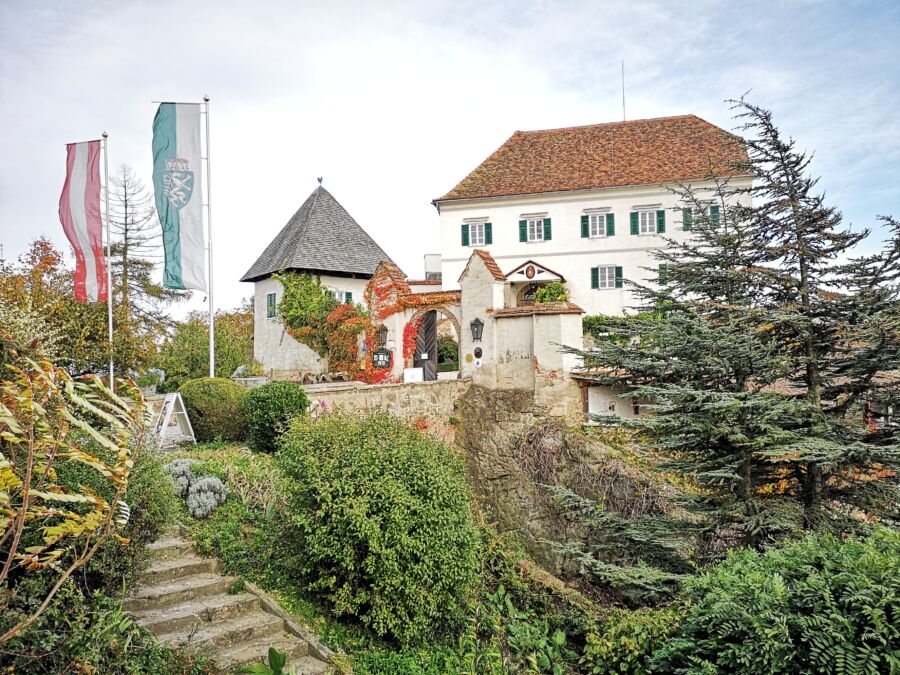 Exterior view of Schloss Kapfenstein in Steiermark, Austria, surrounded by lush green landscapes and vibrant nature