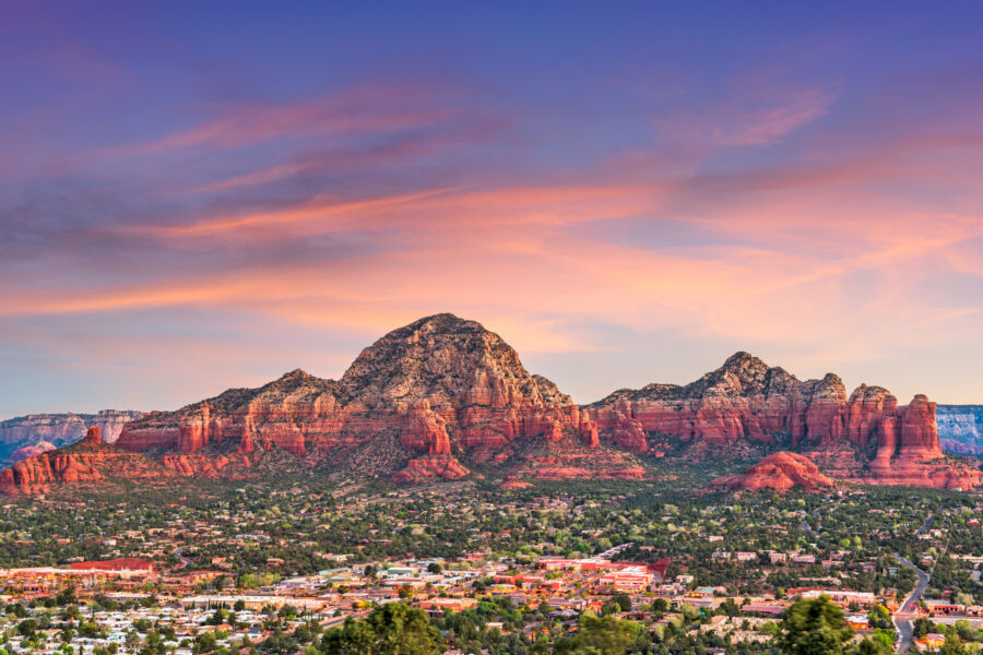 Stunning sunset panorama of Sedona, Arizona, showcasing the vibrant skyline and downtown area against a colorful sky